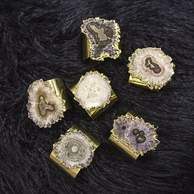 multiple Amethyst Stalactite Cuff Bracelets displayed on black background showing various formations and color between each cuff