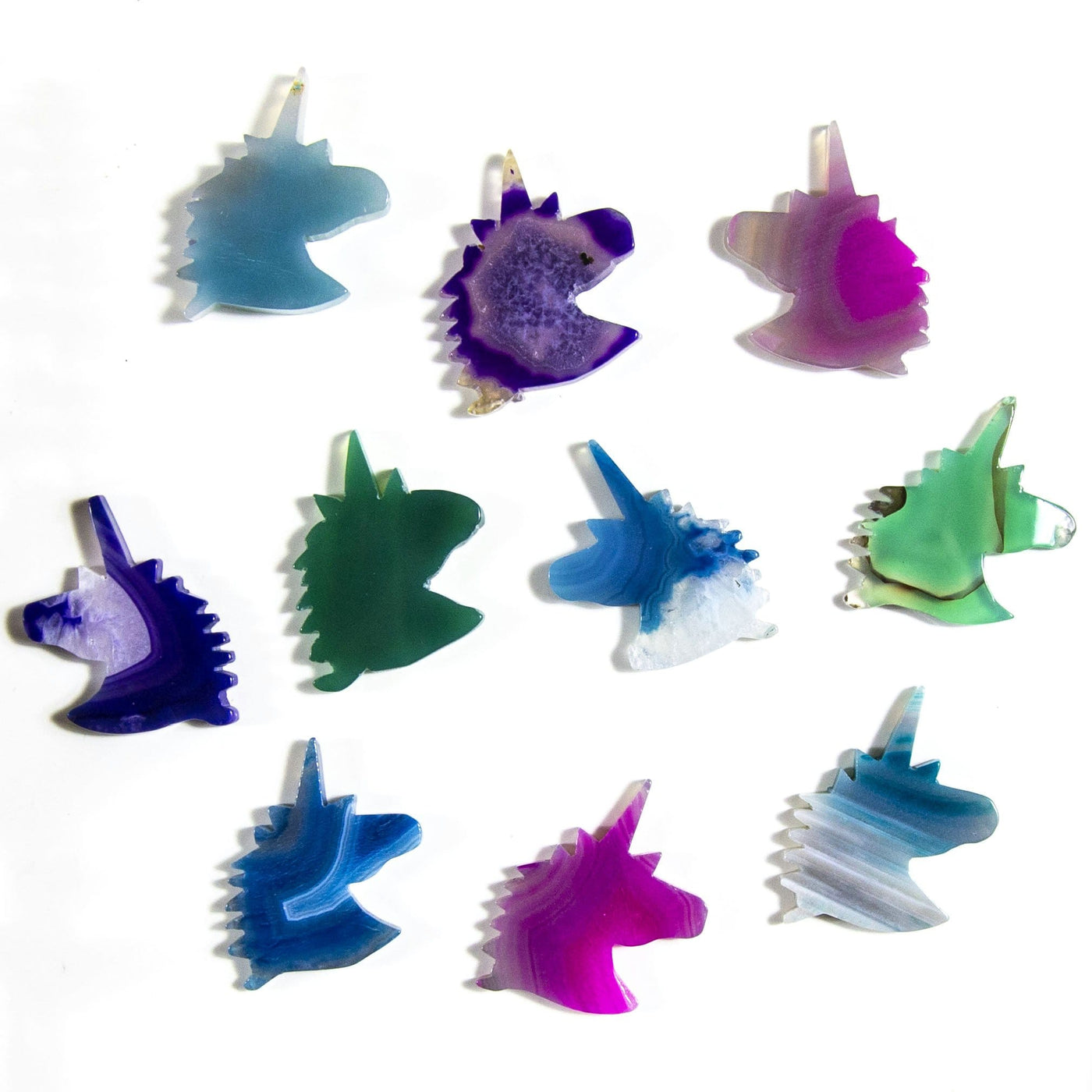 Picture of all the variety of colors we have available for our agate unicorn head. Displayed on a white back ground.