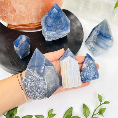 blue quartz points in hand for size reference 