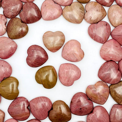 Rhodonite Heart Shaped Stones arranged in a circle on white background