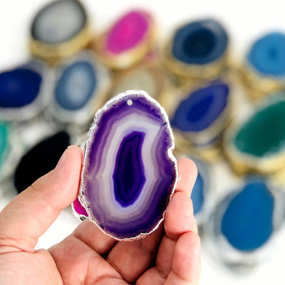 This picture is showing one of our purple/silver agate slices being held in hand for size reference.