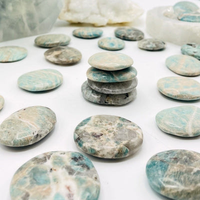 amazonite polished stones being displayed on a white background.