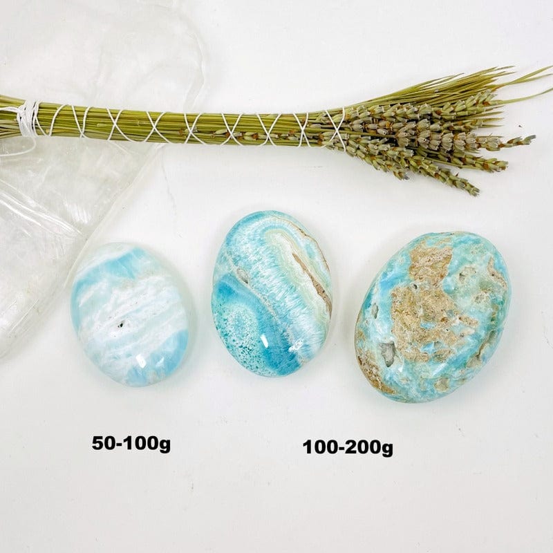 blue aragonite also known as caribbean calcite palm stones showing size difference 