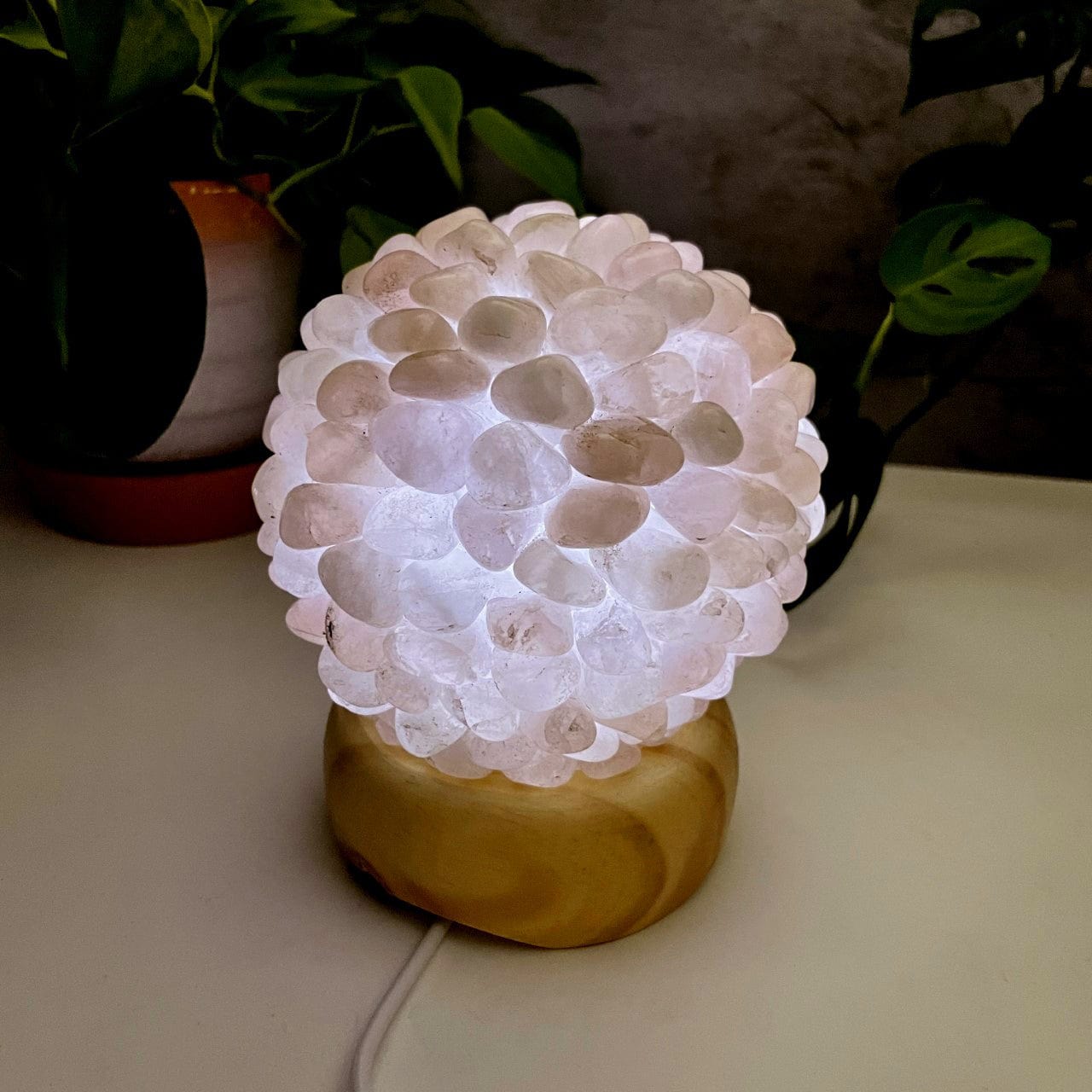 Rose Quartz tumbled stone lamp, lit with the inserted light