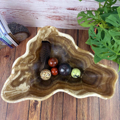 top view of Mexican Onyx Bowl with crystals in it and decorations in the background