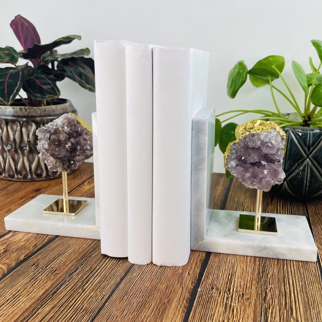 amethyst cluster on marble base bookends used as home decor  