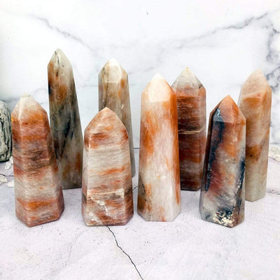 Various Hematoid Quartz Polished Towers displayed to show size differences