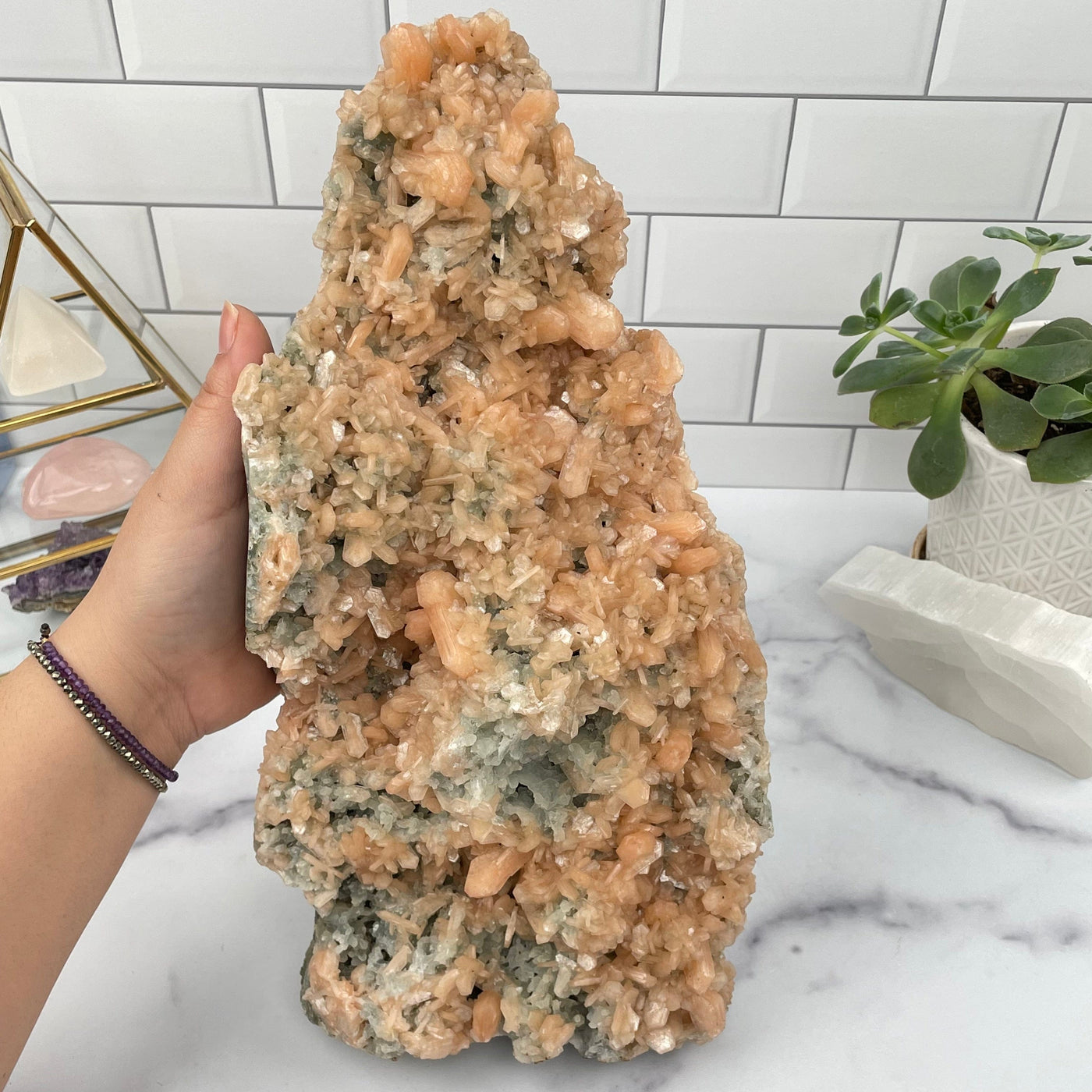Peach Zeolite And Green Apophyllite Formation in hand for size reference 