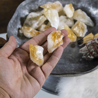 hand holding up citrine points with others in the background