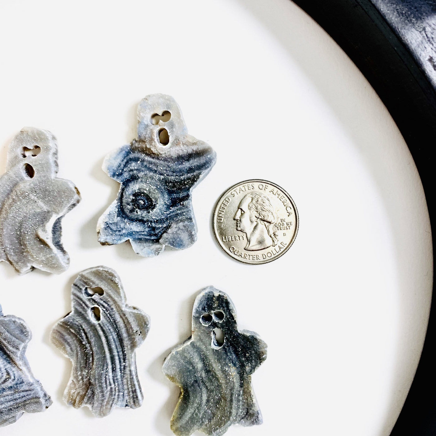 Style 1 Chalcedony Ghost Cabochons next to a quarter for size reference