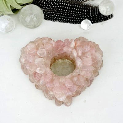 Rose Quartz Tumbled stone Heart Candle Holder with other crystals and decorations in background