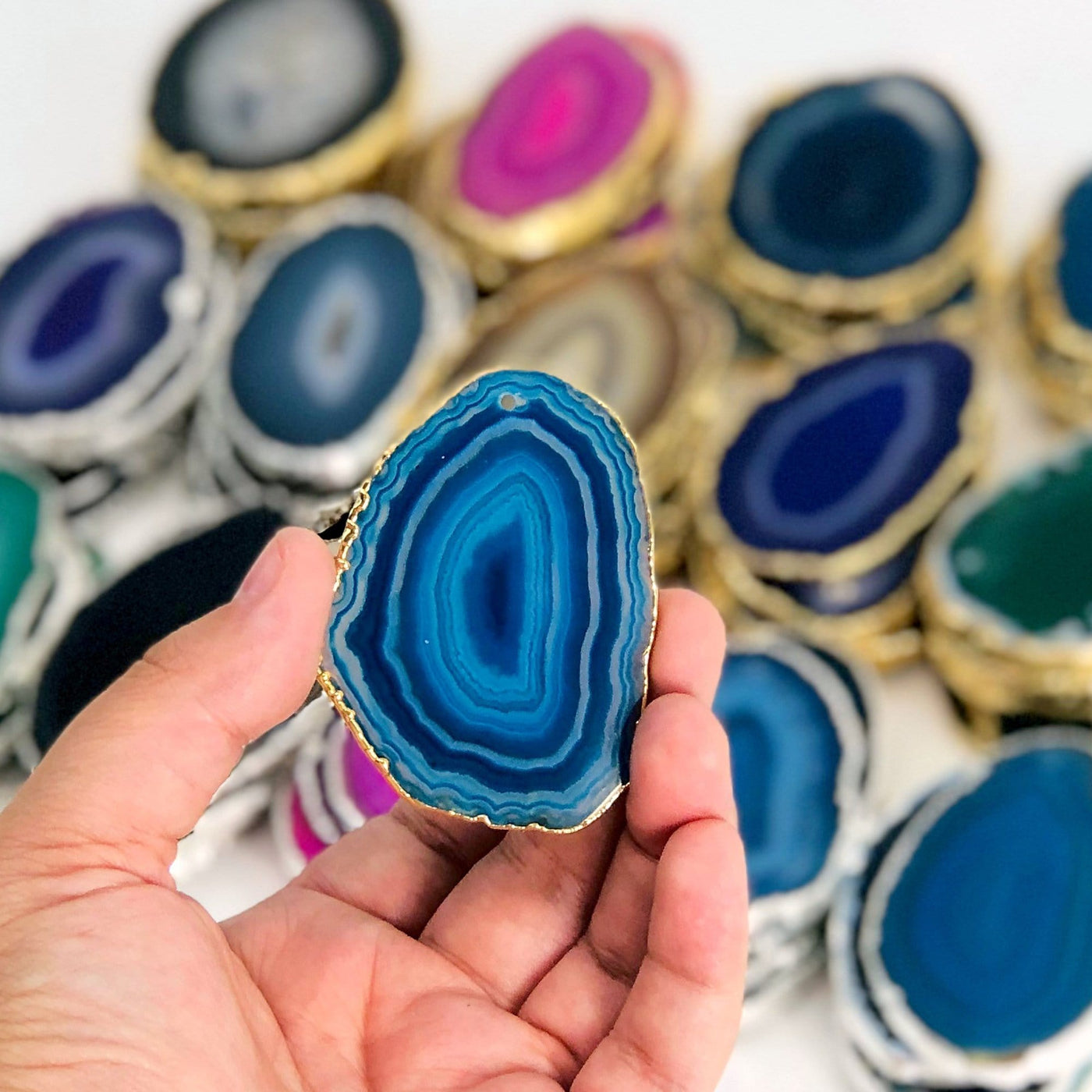 This picture is showing one of our blue/gold agate slices being held in hand for size reference. 