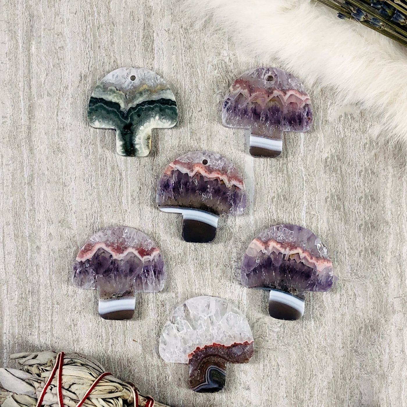 Five Amethyst Mushroom Shaped Large Cabochon and Pendant on a grey background
