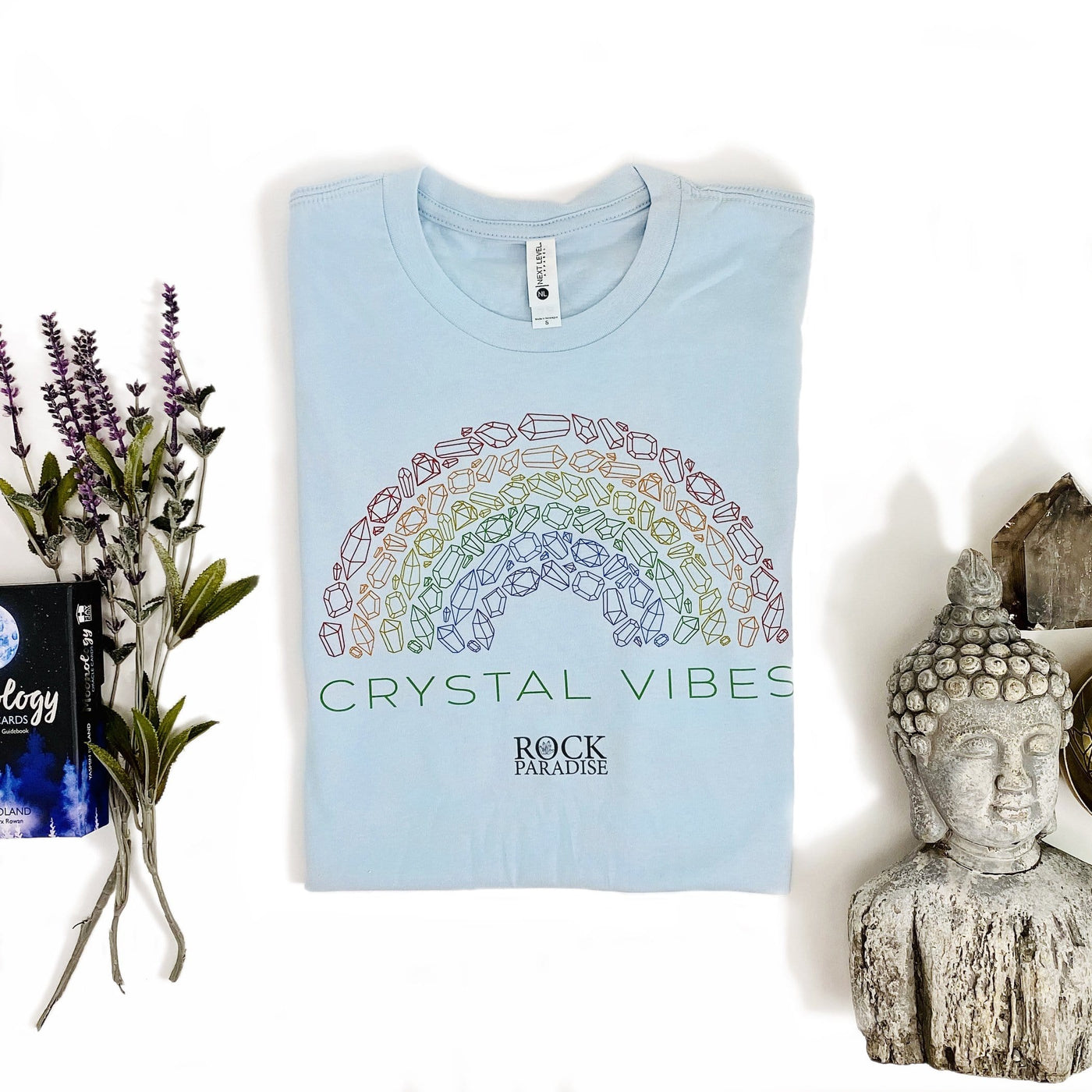 blue Crystal Vibes Shirt with decorations in the background