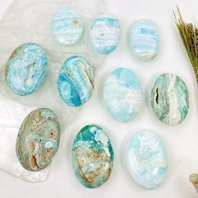 multiple blue aragonite also known as caribbean calcite palm stones laid out to show different styles 