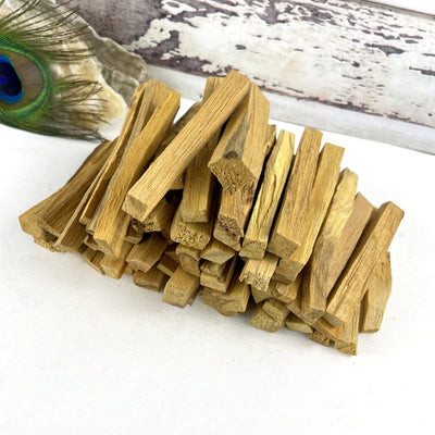 A pile of palo santo sticks on a white background.