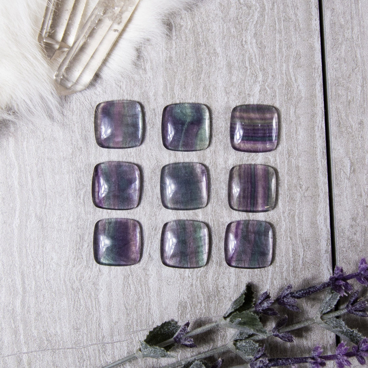 Rainbow Fluorite Square Cabochons displayed on gray background to show various patterns and colors