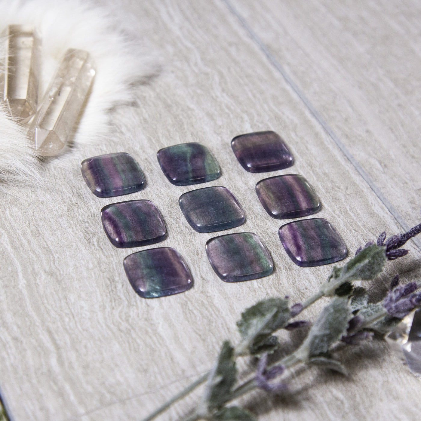 side view of Rainbow Fluorite Square Cabochons for thickness reference