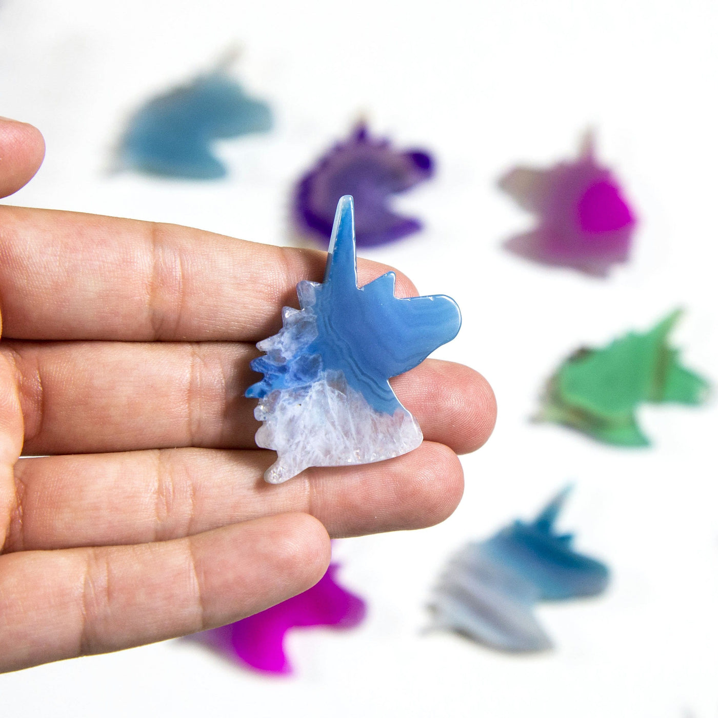 Picture of blue unicorn being held, for size reference.