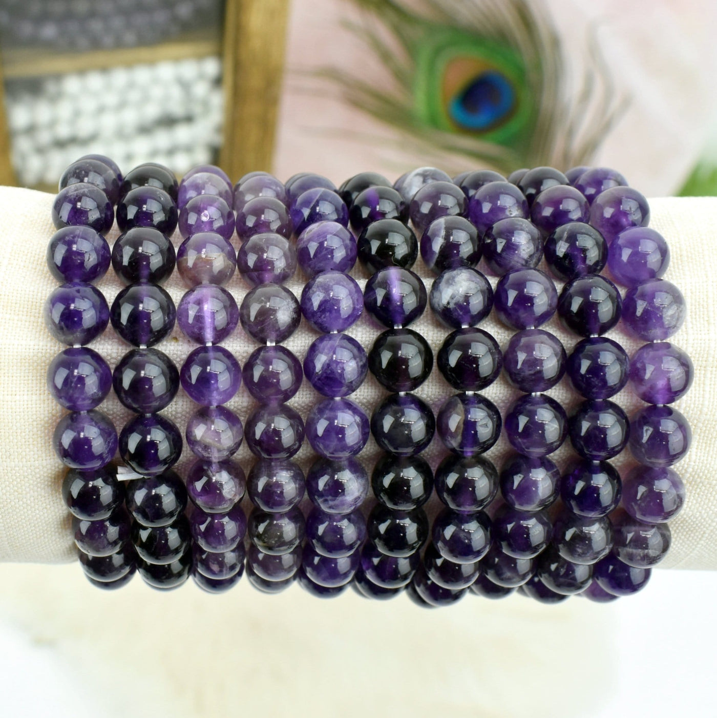 Amethyst Round Bead Bracelets on display with decorations in the background