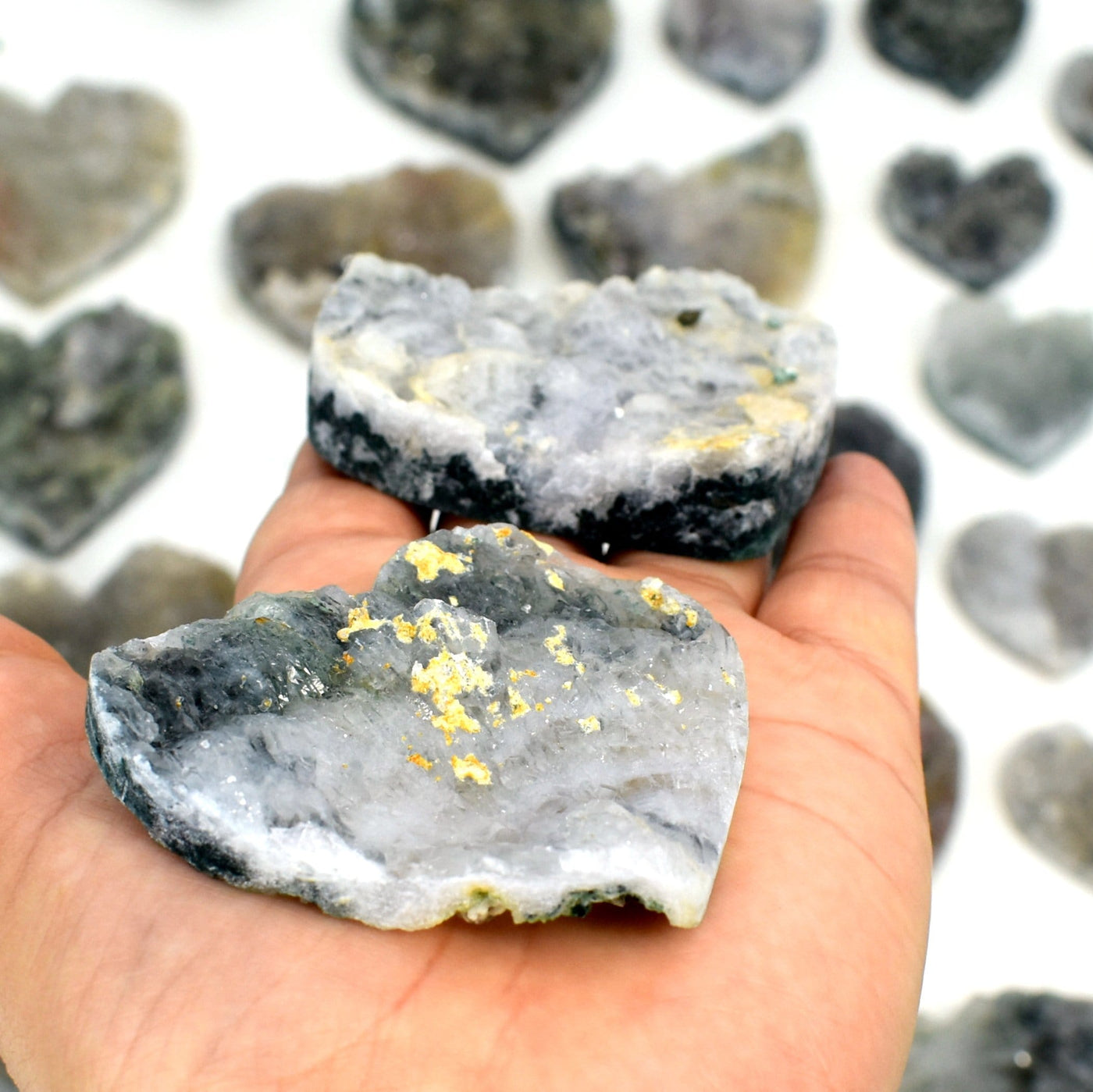 hand showing side view of Amethyst Flower Hearts