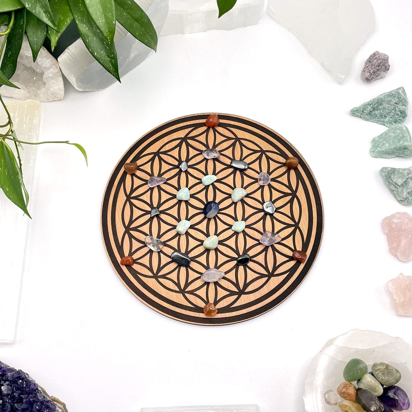 flower of life crystal grid with stones on it