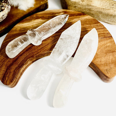 3 Crystal Quartz Knifes with decorations in the background