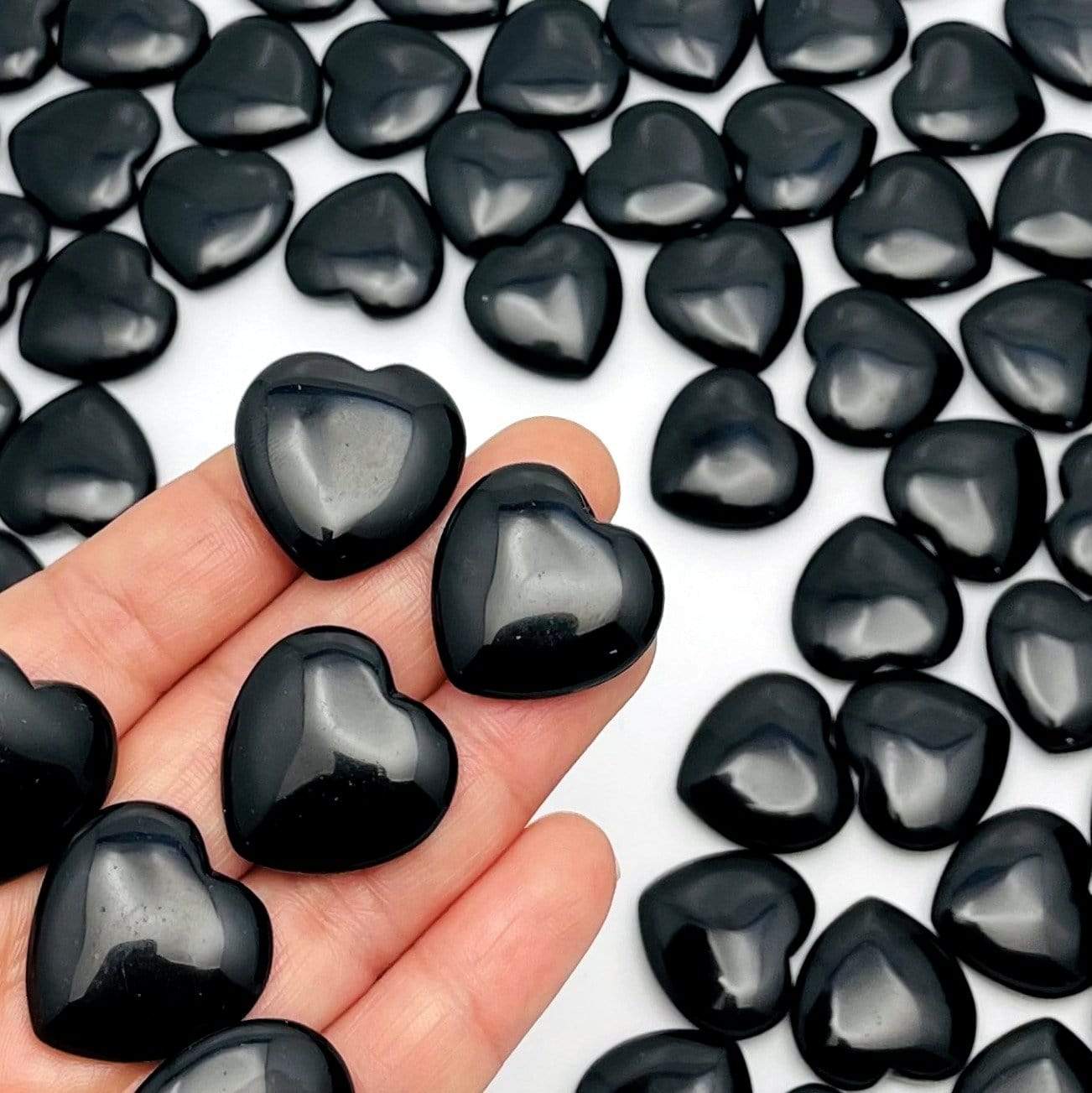 close up shot of obsidian hearts displayed in hand