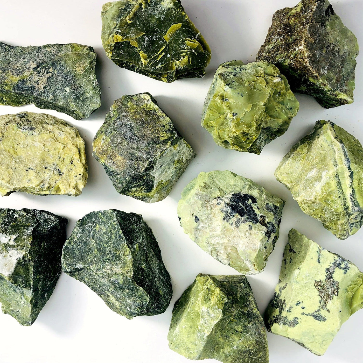 overhead view of many serpentine rough stones for possible variations