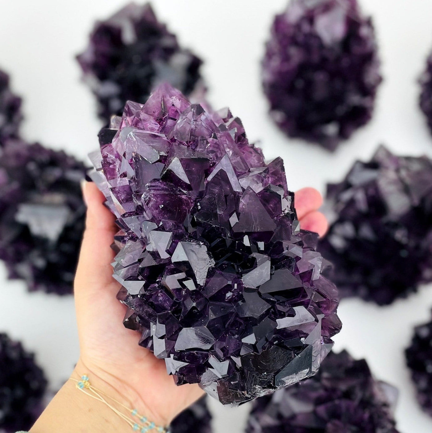 purple salt crystal formation in hand for size reference