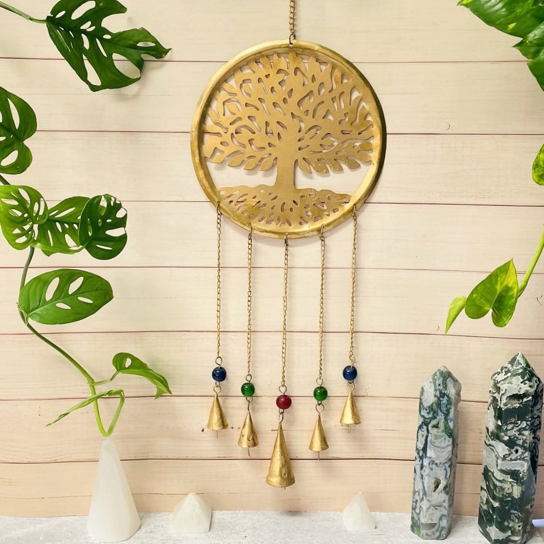 Brass Tree of Life wall Hanging on a wall with red, blue and green beads and bells on chain