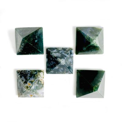 Moss agate assorted pyramids on a white background.