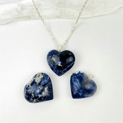 sodalite heart on a chain and 2 laying next to it