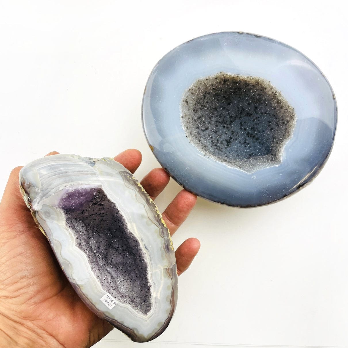2 Agate Geodes with Druzy Centers overhead with 1 in a hand
