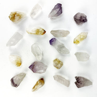 Triple Energy Set of Quartz, Amethyst and Citrine Points spread out on a table