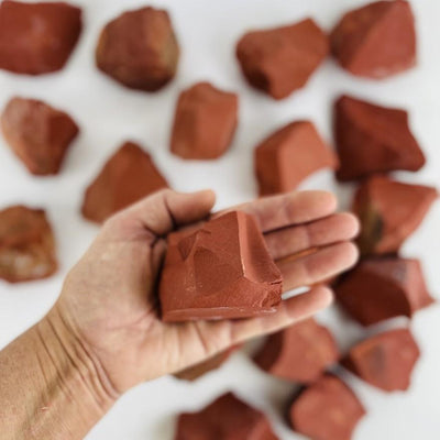 red jasper stone in hand for size reference 