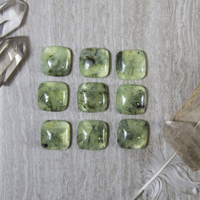 Prehnite Square Cabochons lined up to show various formations and color