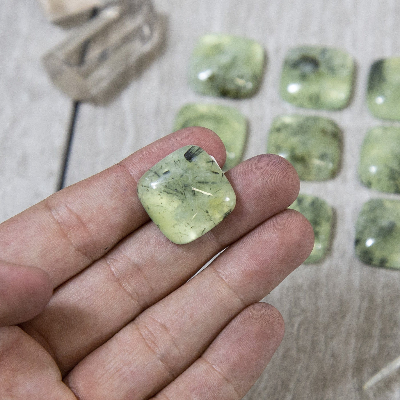 Prehnite Square Cabochon in hand for size reference