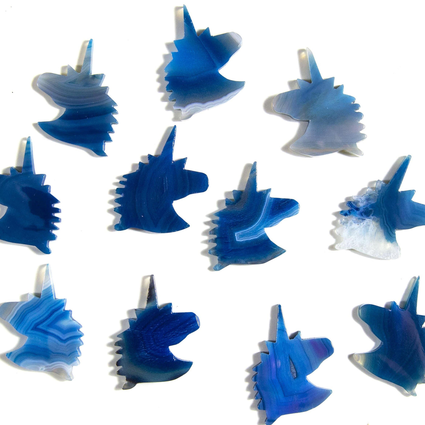 Blue agate unicorn heads being displayed on a white background.