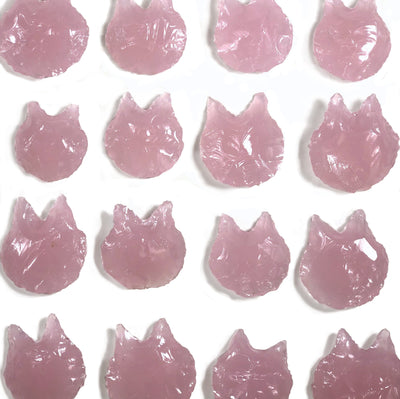 16 rose quartz cats laid out on a white background