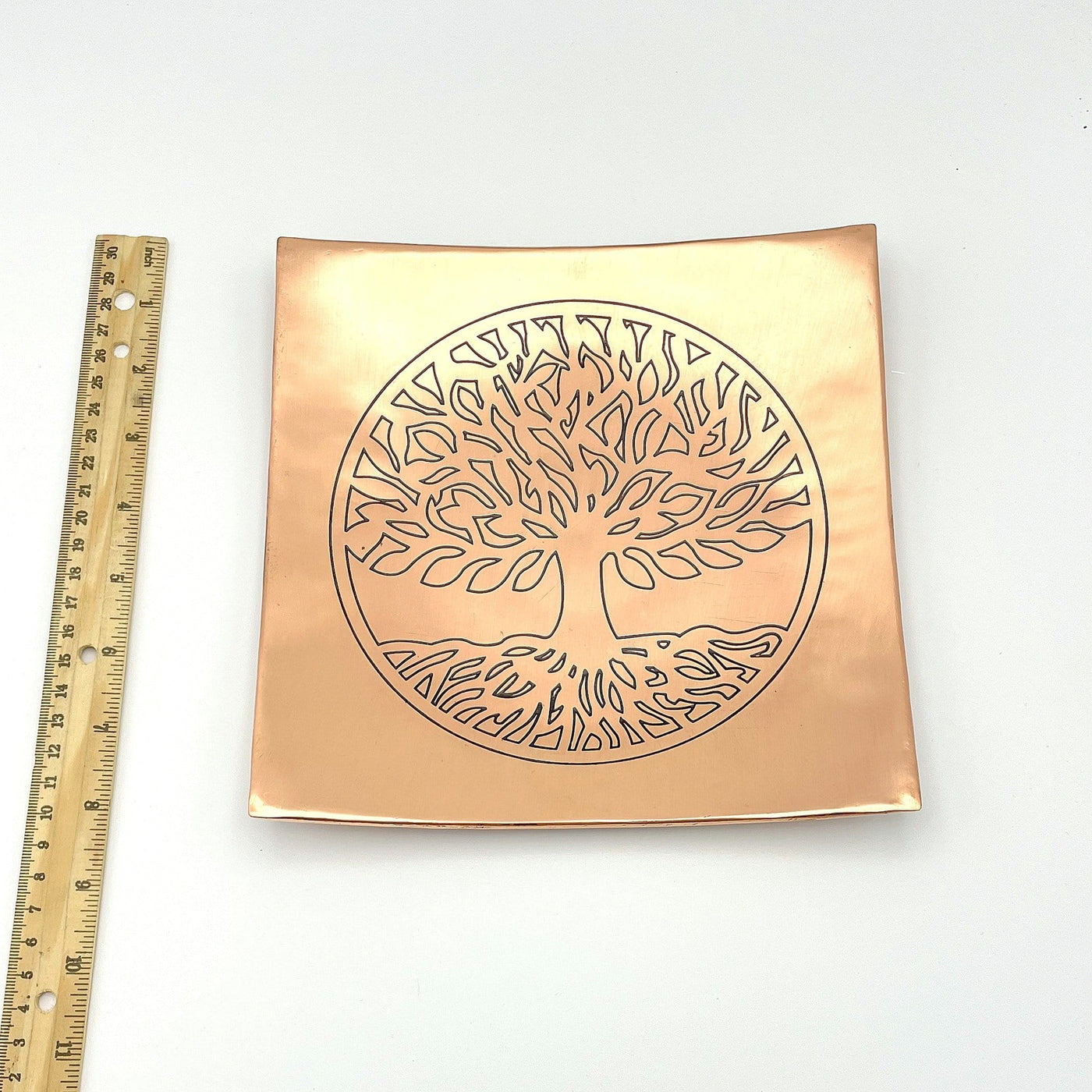 square copper dish with a ruler 