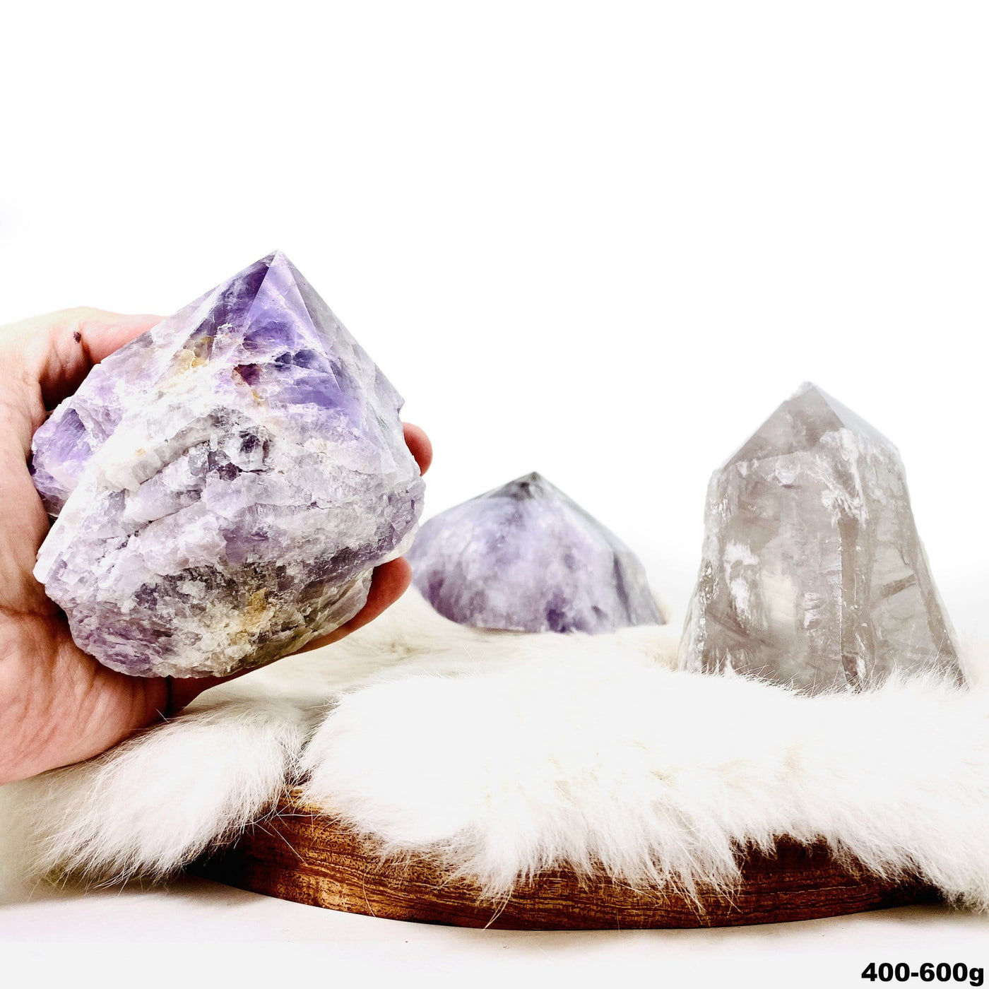 Picture of three amethyst ametrine semi polished points displayed on a fury surface.