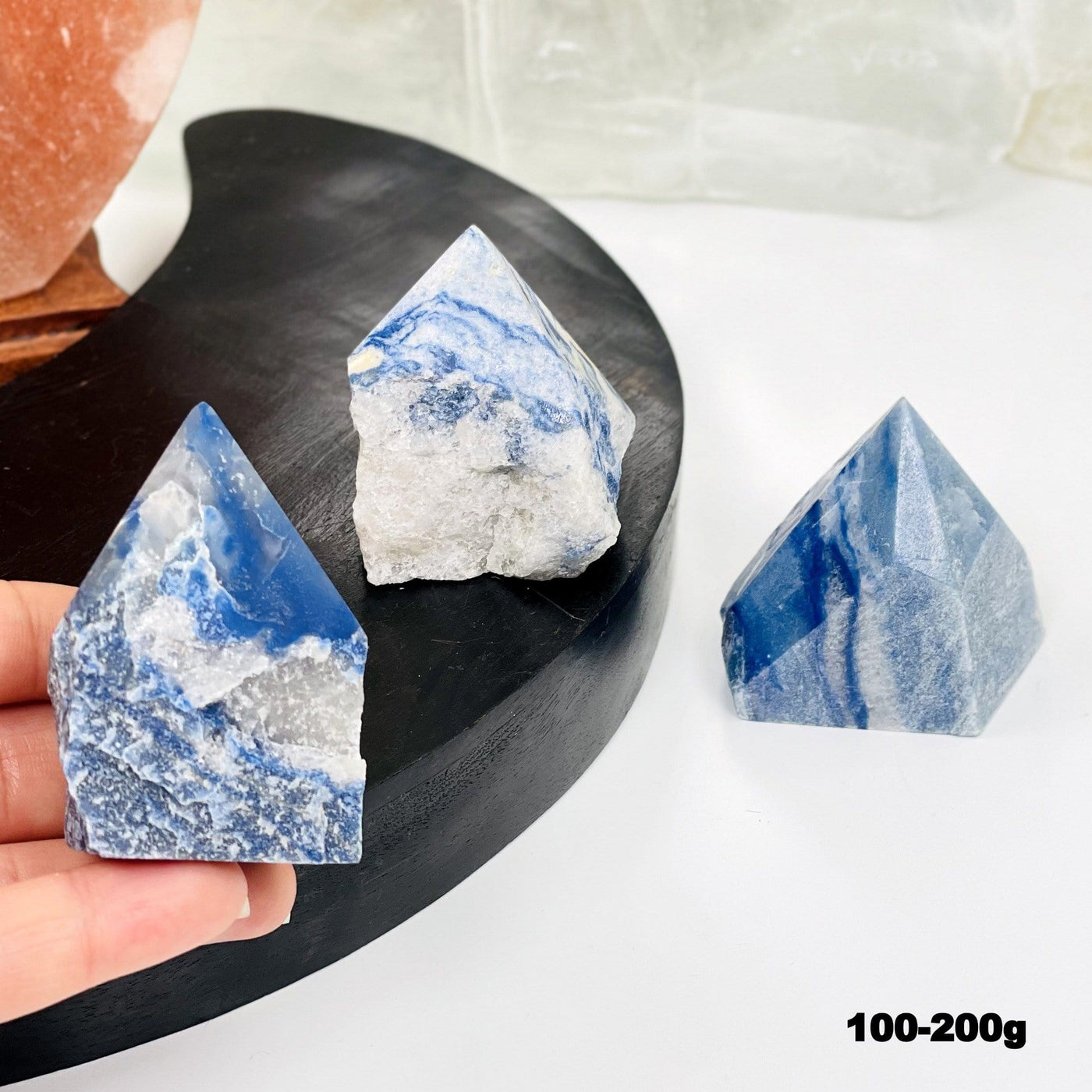 blue quartz point in hand for size reference 