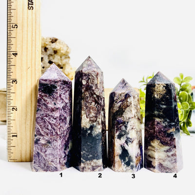 4 Charoite Polished Towers next to a ruler for size reference