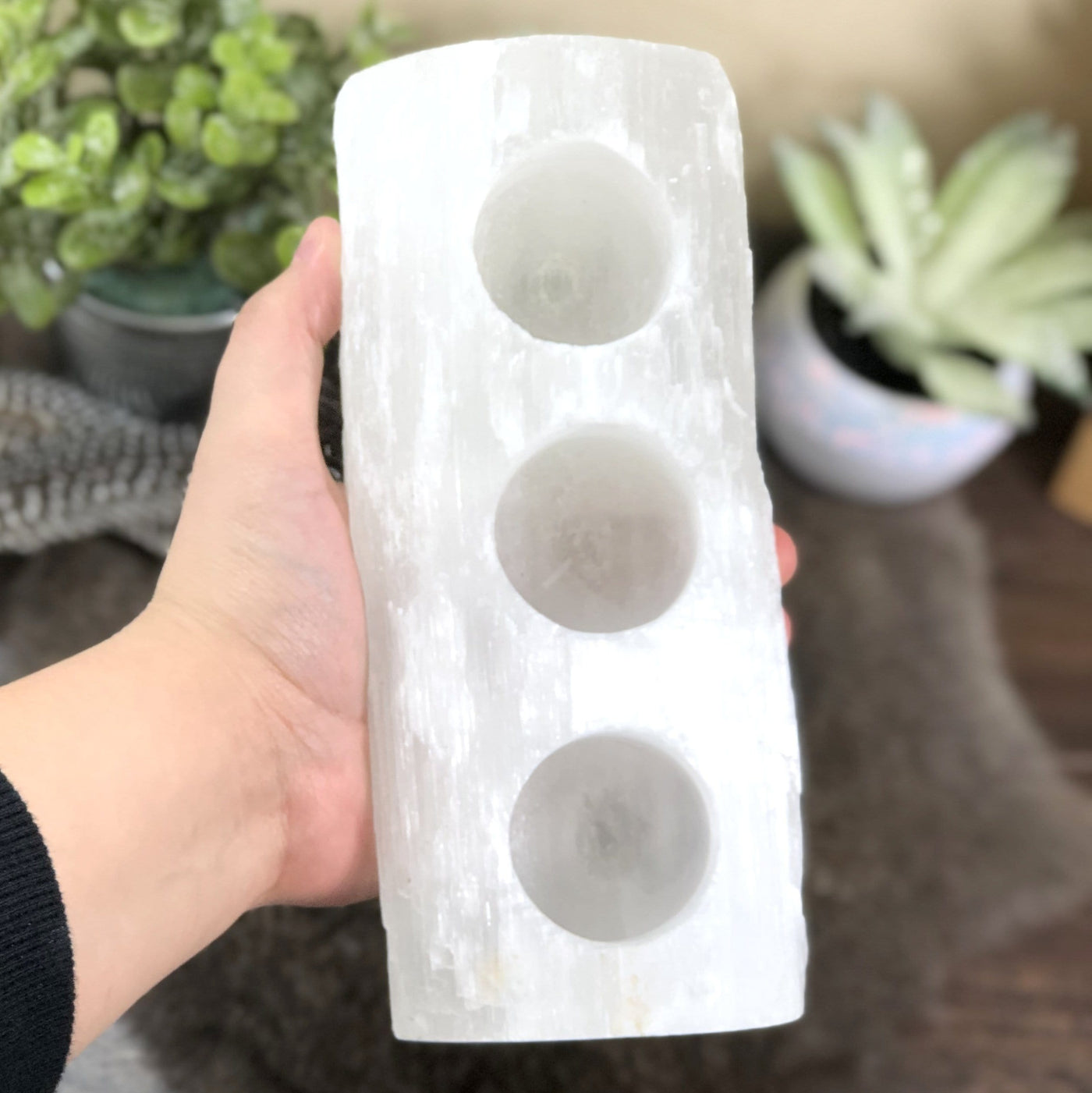 3 votive selenite candle holder in hand for size reference