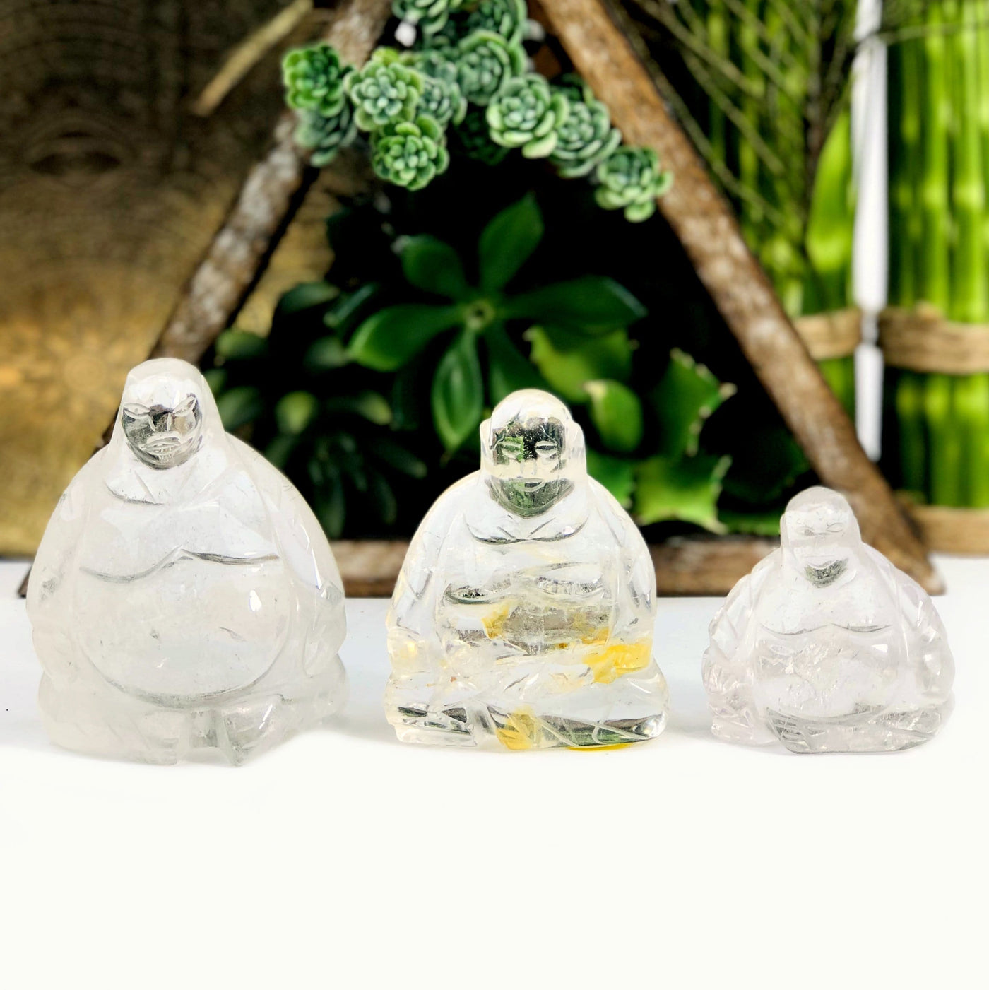 Crystal Quartz Sitting Buddha Mini Statues lined up from biggest to smallest size