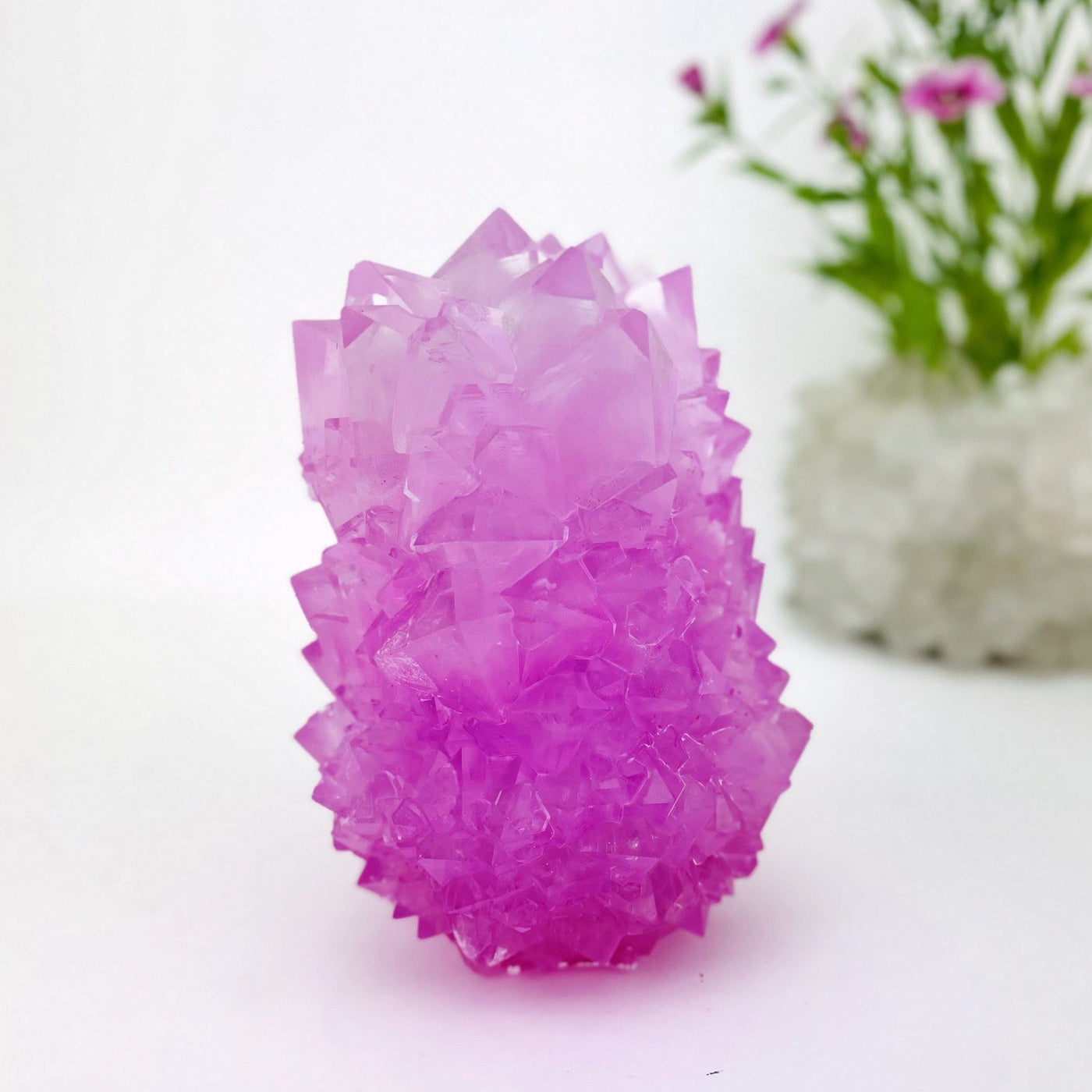 close up of small pink salt crystal formation on display for details