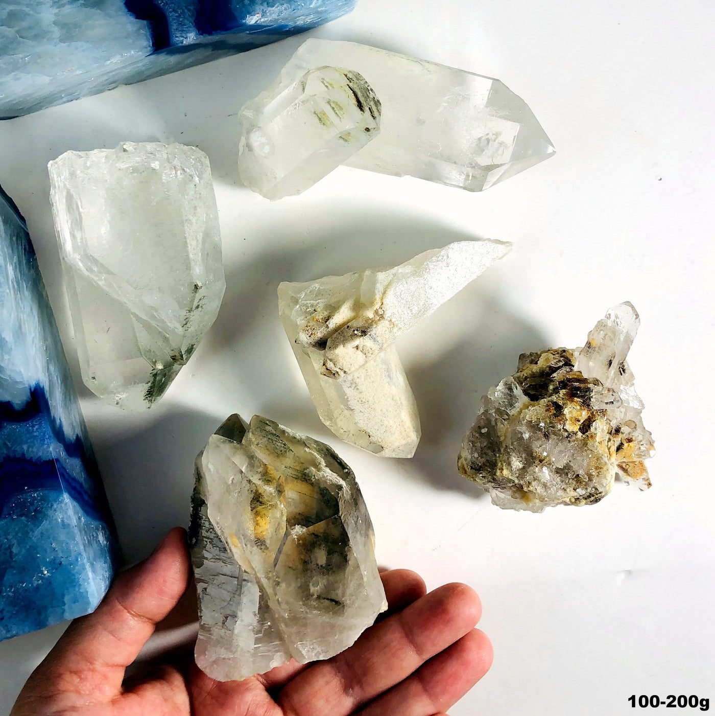 101-200g of the Crystal Quartz with Chlorite Raw Clusters in hand for size reference