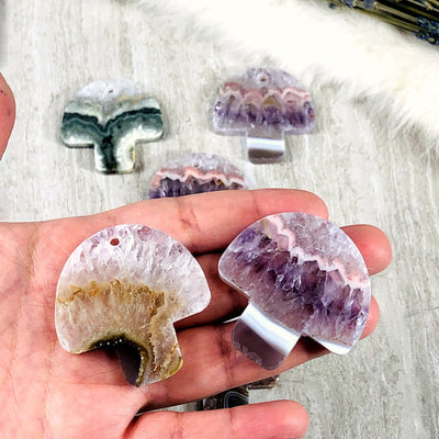 Two Amethyst Mushroom Shaped Large Cabochon and Pendant  in hand for size comparison