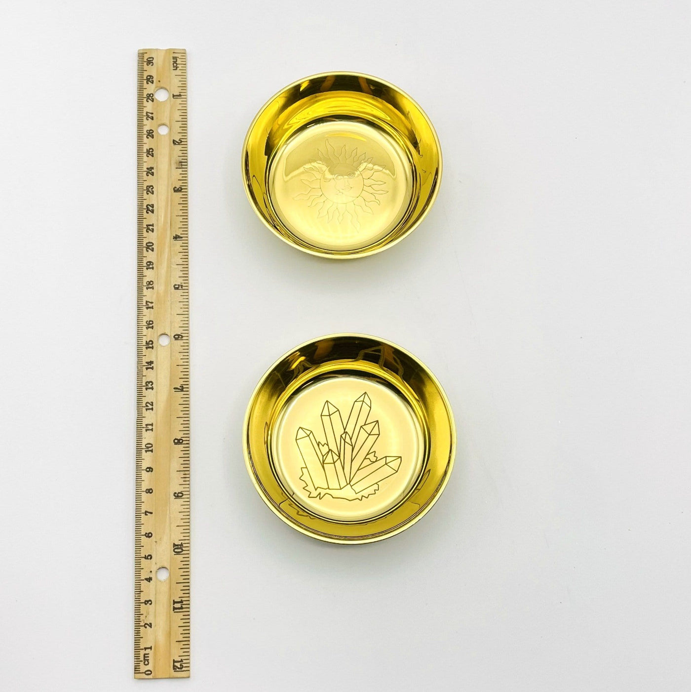 Brass Offering Bowls in both sun and moon and crystals next to ruler for size comparison